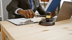 A man slamming down a gavel looking at a lap top as part of the American AI Initiative.