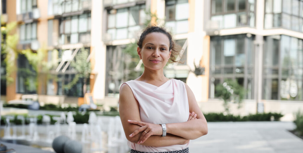 Smiling businesswoman using tablet in modern office building