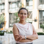 Smiling businesswoman using tablet in modern office building