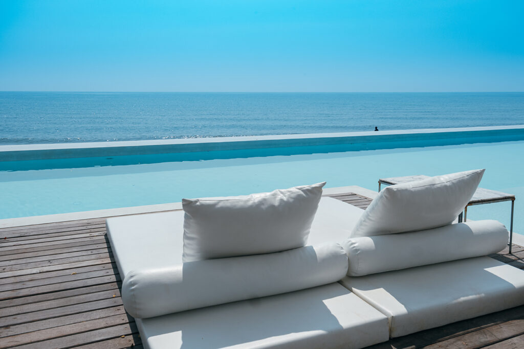 luxury swimming pool on sea view and beach chair in hotel resort