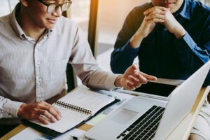 Two members of an ai consulting firm working together on a project.