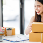 An Asian woman with several parcels running a thriving small business because she read the ai consulting practical guide for small business leaders.