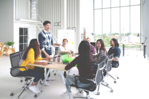 Group of multiracial young team discussing a project as per the ai consulting practical guide for small business leaders.