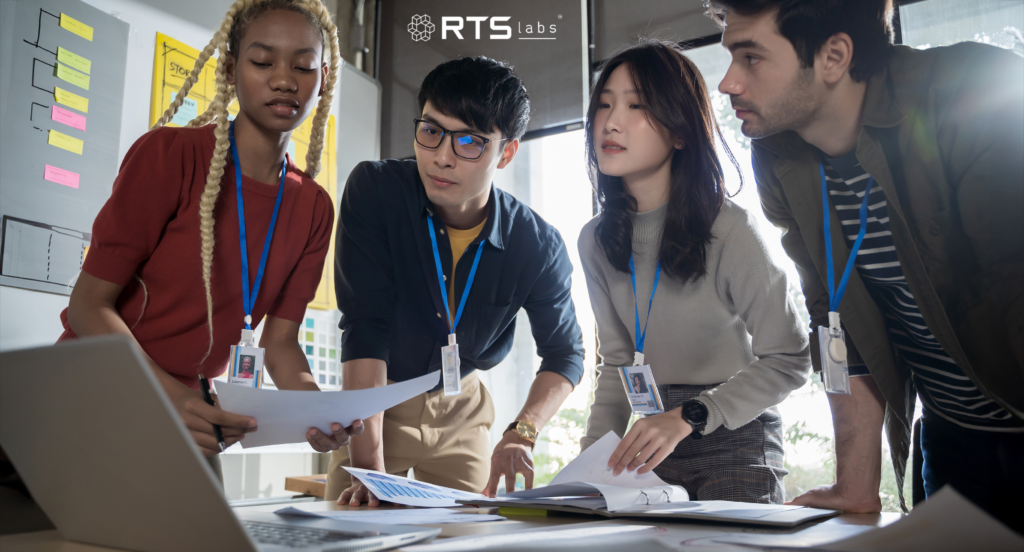 Team at a startup strategizing around a computer using one of the many top ai tools for small businesses.