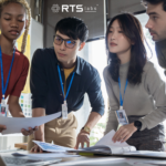 Team at a startup strategizing around a computer using one of the many top ai tools for small businesses.