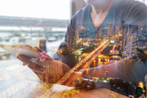 Man using technology with an overlay of city lights depicting supercharging generative technology.