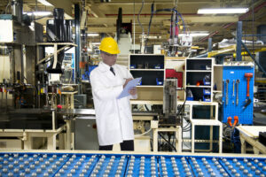 Man working in manufacturing with clipboard