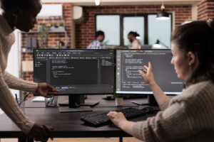 Two talented women discussing code at a leading ai consulting firm