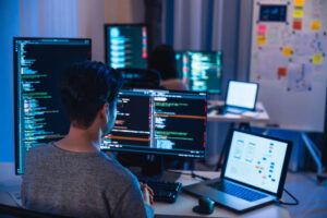 people coding in dimly lit room