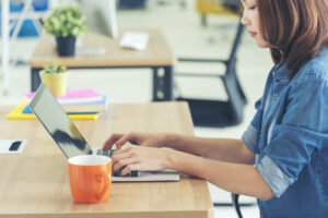 Woman on computer working with AI in marketing.