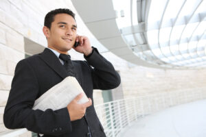 Young businessman looking confident because his department benefited from a high return on AI