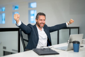 Man at computer excited because of AI.