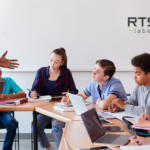 A black teacher man talking to his students with computers using ai in education.