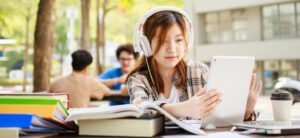 A high school girl using a tablet when studying taking advantage of AI in education.