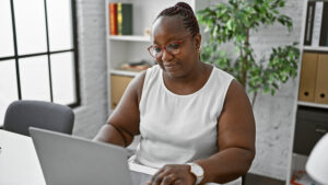 Black woman working on a computer with emergence orchestrator