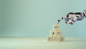 AI robot touching wooden blocks with symbols on them.