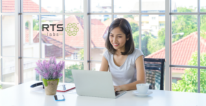 Asian woman on a computer happy to use the assistance of an AI agent in the agentic age.