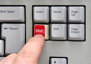 A finger pressing a red "panic" button symbolizing the importance of AI in mental health