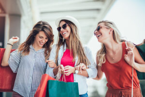 Women with shopping bags excited because they got ai personalized recommendations.