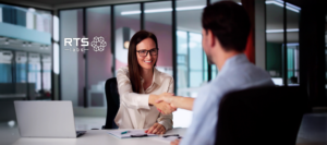 A woman shaking hands with a man hiring AI consultants for her company.