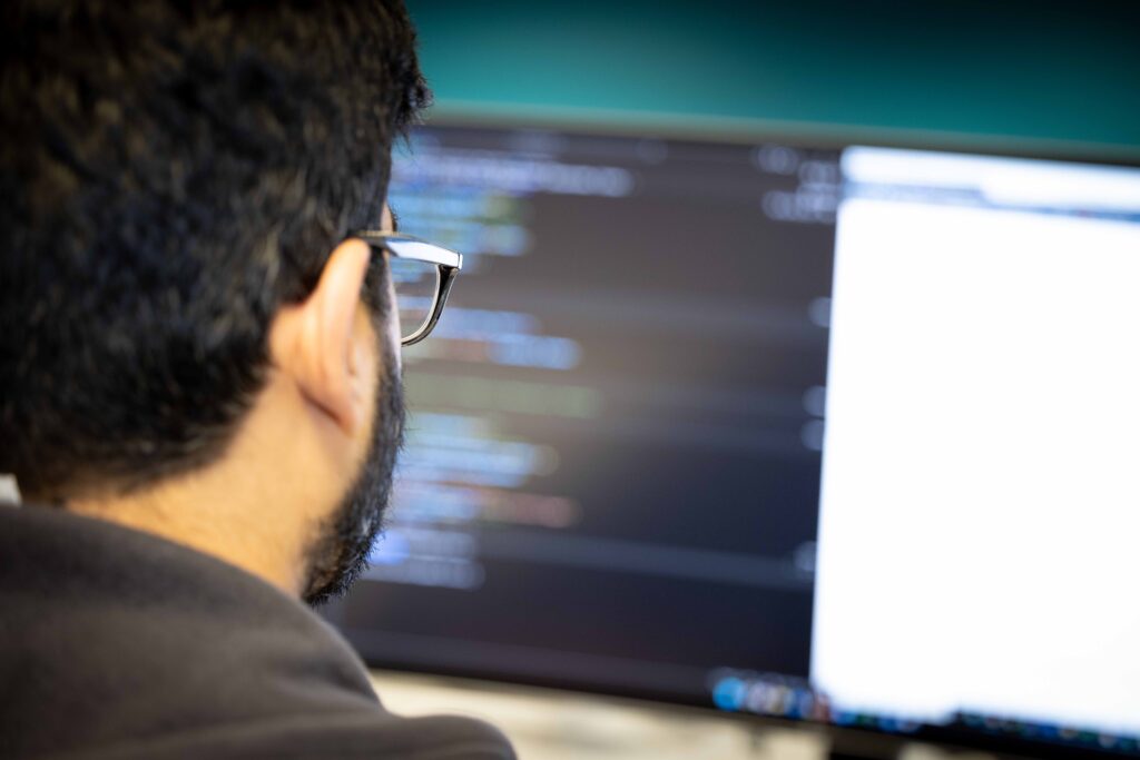An RTS Labs engineer reviewing code on screen