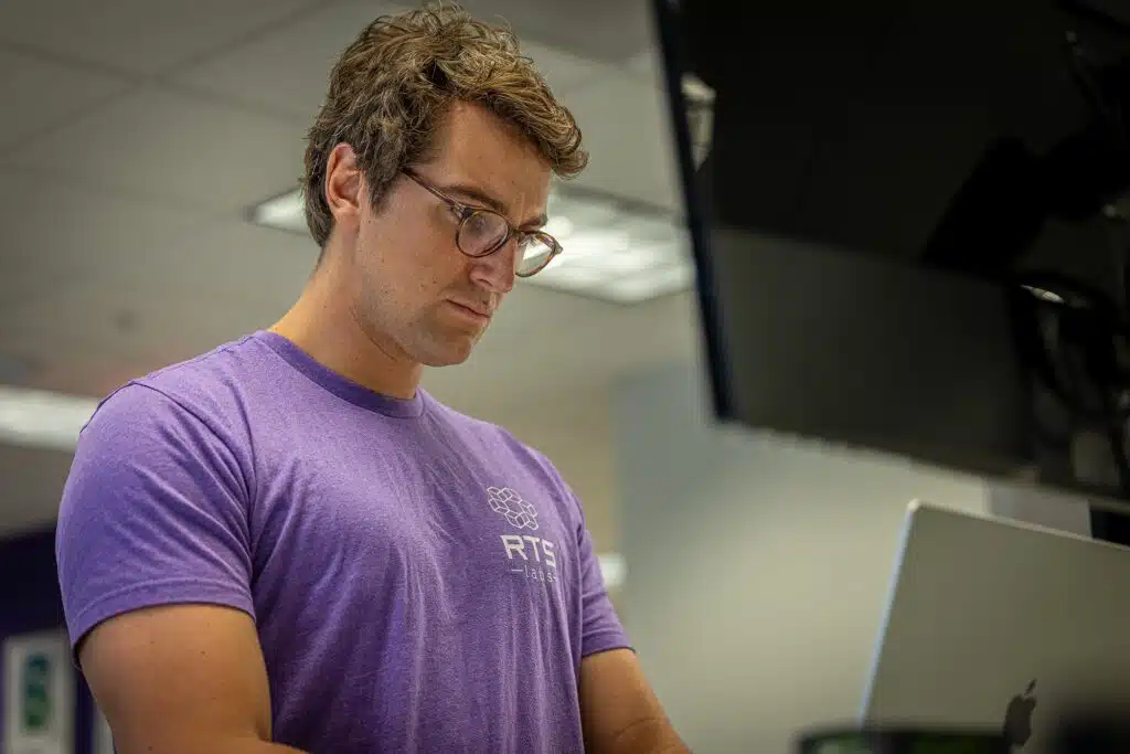 An RTS Labs engineer focused on his work at the office